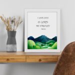 Infidu Psalm 18:1 Bible wall art with a serene mountain and river illustration, black text on a white background. Wall Art displayed on the table in a white frame