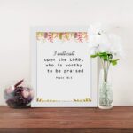 I Will Call Upon The Lord Psalm 18:3 Bible Verse Wall Art with handwritten text and colorful floral elements on a white background. Wall Art displayed on the table in a white frame