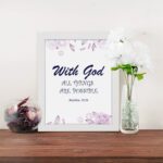 With God All Things Are Possible Matthew 19:26 Bible Verse Wall Art with purple text and light purple floral accents on a white background. Wall Art displayed on the table in a white frame