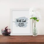 With God All Things Are Possible Matthew 19:26 Bible Verse Wall Art with black text and light blue brushstroke on white background. Wall Art displayed on the table in a white frame