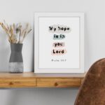 Colorful My Hope Is In You Lord Bible Verse Wall Art in soft pink, green, and blue on a white background Wall Art displayed on the table in a white frame