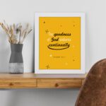 Bright mustard yellow wall art with Psalm 52:1. God in gold and playful font with star-like designs. Wall Art displayed on the table in a white frame