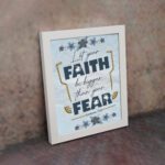 Infidu Let Your Faith Be Bigger Than Your Fear Hebrews 13:6 Christian Wall Art with blue and yellow floral design Wall Art displayed on the wall in a white frame