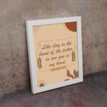 Infidu Jeremiah 18:6 Christian wall art with cursive brown text on a beige background, flanked by wheat stalks and pottery silhouettes. Wall Art displayed on the wall in a white frame