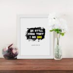 Be Still and Know That I Am God Psalm 46:10 Christian wall art with handwritten text on a navy blue background. Wall Art displayed on the table in a white frame