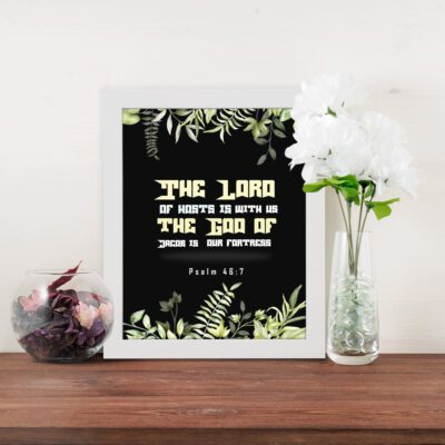 The Lord of Hosts is With Us Psalm 46:7 Bible Verse Wall Art with green leaves and bold cream and white text. displayed on the table in a white frame