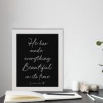 He Has Made Everything Beautiful Ecclesiastes 3:11 Christian Bible Verse Wall Art with White Text on Black Background. displayed on the floor in a white frame