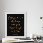 Blessed Are All Those Who Put Their Trust In Him Psalm 2:12 golden text on black background - Christian wall art displayed on the table in a white frame