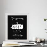 Infidu The Goodness of God Endures Continually Psalm 52:1 Bible Verse Wall Art with white text on black background. Wall Art displayed on the table in a white frame