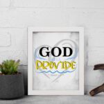 God Will Provide Christian wall art with bold black 'God,' gray and yellow text, and a heart-like light gray background. Wall Art displayed on the wall in a white frame