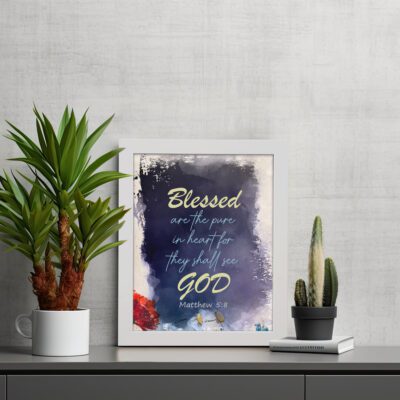 Infidu Matthew 5:8 Christian wall art with yellow text on a dark blue textured background, featuring bright yellow 'GOD' and a hint of red floral design. Wall Art displayed on the table in white frame