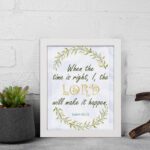 Infidu Isaiah 60:22 Christian wall art with green and gold text, gold LORD, and a wreath of green leaves on a white background. Wall Art displayed on the wall in a white frame