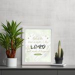 Infidu Isaiah 60:22 Christian wall art with gold text on mint green background, featuring LORD in larger black and beige letters. Wall Art displayed on the table in a white frame