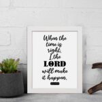 Infidu wall art displaying When the time is right, I, the LORD will make it happen in black text on a white background. displayed on the table in a white frame