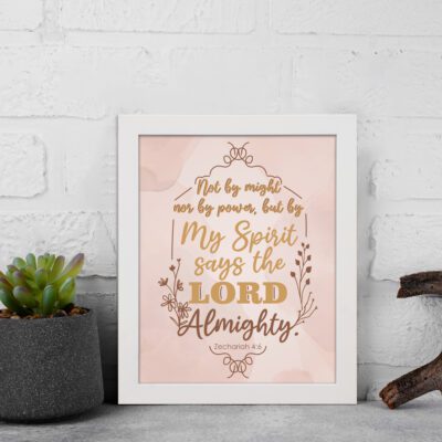 Zechariah 4:6 Christian wall art featuring Not By Might Nor By Power in gold script on a light peach background with floral accents. Wall Art kept on the wall in a white frame