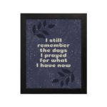 Infidu, I still remember the days I prayed for what I have now. Bible Verse wall art with a purple-blue background, black leaf design, and white font is perfect for home office decor and black frames hung on the wall.