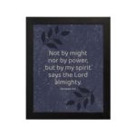 Christian wall art with Zechariah 4:6 verse on purple-blue background with leaf design and black frame hung on the wall