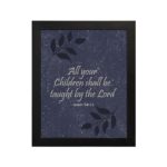 Christian wall art with Isaiah 54:13 verse on purple-blue background with leaf design and black frame hung on the wall