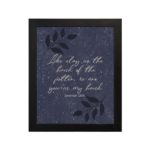 Christian wall art with Jeremiah 18:6 verse on purple-blue background with leaf design black frame hung on the wall.