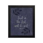 Purple-blue background with black leaf design, white text 'Trust In The Lord And Do Good Psalm 37:3 Bible Verse Wall Art black frame hung on the wall