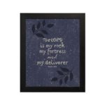 Christian wall art with purple-blue background, black leaf design, and white text The Lord Is My Rock My Fortress And My Deliverer Psalm 18:2 Bible Verse Wall Art black frame hung on the wall