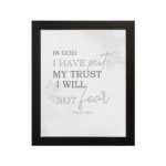 Christian wall art featuring Psalm 56:4 Bible verse on a gray background with gray leaf design and black and gray font black frame hung on the wall.