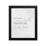 Christian wall art featuring Isaiah 54:13 Bible verse on a gray background with gray leaf design and black and gray font and black frame hung on the wall.