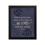 Christian wall art with purple-blue background, black leaf design, and white text And Everyone Who Calls On The Name Of The Lord Will Be Saved Acts 2:21 Bible Verse Wall Art black frame hung on the wall