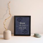 Christian wall art with purple-blue background, black leaf design, and white text Bless The Lord O My Soul Psalm 103:1 Bible Verse Wall Art black frame displayed on the wall