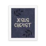 Christian wall art with purple-blue background, black leaf design, and white text Infidu Jesus Christ Bible Verse Wall Art white frame hung on the wall