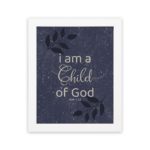 Christian wall art with purple-blue background, black leaf design, and white text I Am A Child Of God John 1:12 Bible Verse Wall Art white frame hung on the wall