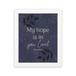 Purple-blue background with black leaf design, white text My Hope Is In You Lord Psalm 39:7 Bible Verse Wall Art white frame hung on the wall.