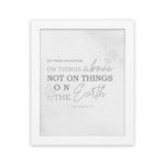 Gray background with leaf design, black and gray text 'Set Your Affection On Things Above Colossians 3:2 Bible Verse Wall Art and white frame hung on the wall.