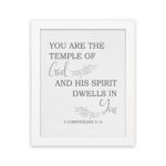 Christian wall art featuring the verse You Are The Temple Of God, His Spirit Dwells In You from 1 Corinthians 3:16 on a gray background with gray leaf design and black and gray font white frame hung on the wall.