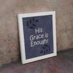 Christian wall art with In God I Have Put My Trust I Will Not Fear Psalm 56:4 on a purple-blue background with a leaf design white frame on the wall