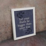 Christian wall art with Hebrews 13:6 verse on purple-blue background with leaf design white frame on the wall