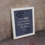 Christian wall art with Psalm 115:3 text on Purple Blue Color background, black leaf design, white font white frame on the wall