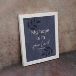 Purple-blue background with black leaf design, white text My Hope Is In You Lord Psalm 39:7 Bible Verse Wall Art white frame on the wall.