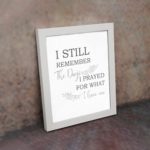 Christian wall art featuring the phrase I Still Remember The Days I Prayed For What I Have Now on a gray background with a gray leaf design and black and gray font white frame on the wall.