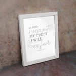 Christian wall art featuring Psalm 56:4 Bible verse on a gray background with gray leaf design and black and gray font white frame on the wall.