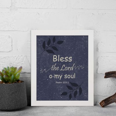 Christian wall art with purple-blue background, black leaf design, and white text Bless The Lord O My Soul Psalm 103:1 Bible Verse Wall Art black frame displayed on the wall