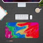 Infidu Artistic Desk Pad with swirling, marbled pattern in vibrant colors of red, blue, purple, green, and yellow. Design Kept on a computer table