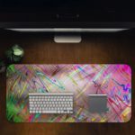 Infidu Artistic Desk Pad with an abstract marbled design in pastel colors pink, blue, green, and yellow with paint-like strokes and splatters. Desk Pad in computer table