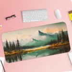 Desk pad featuring a serene landscape of mountains, pine trees, and a calm lake with a soft blue and green color palette. Desk Pad with Keyboard and Mouse