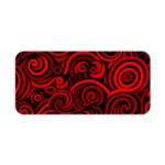 Desk pad with bold red and black spirals on a dark background, creating a hypnotic effect. Desk Pad kept on a plain white background