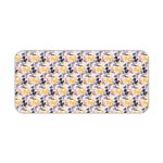 Desk pad with a white background featuring a pattern of small blue and purple flowers or geometric shapes. Desk Pad kept on a plain white background