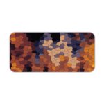 Desk mat featuring an abstract mosaic pattern with irregular shapes in shades of black, blue, gray, and yellow. Desk Pad kept on a plain white background