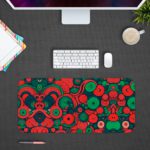 Desk pad with an abstract pattern of overlapping circles and swirls in red, green, and dark blue. Design Kept on a computer table