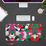 Colorful abstract desk pad with playful patterns, featuring pink, green, red, black, and white shapes resembling flowers and circles. Design Kept on a computer table