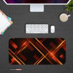 Desk pad with a black background and glowing golden lines forming a diamond pattern. Desk Pad kept on a gray background